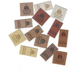 Collection of branded leather labels on a white background