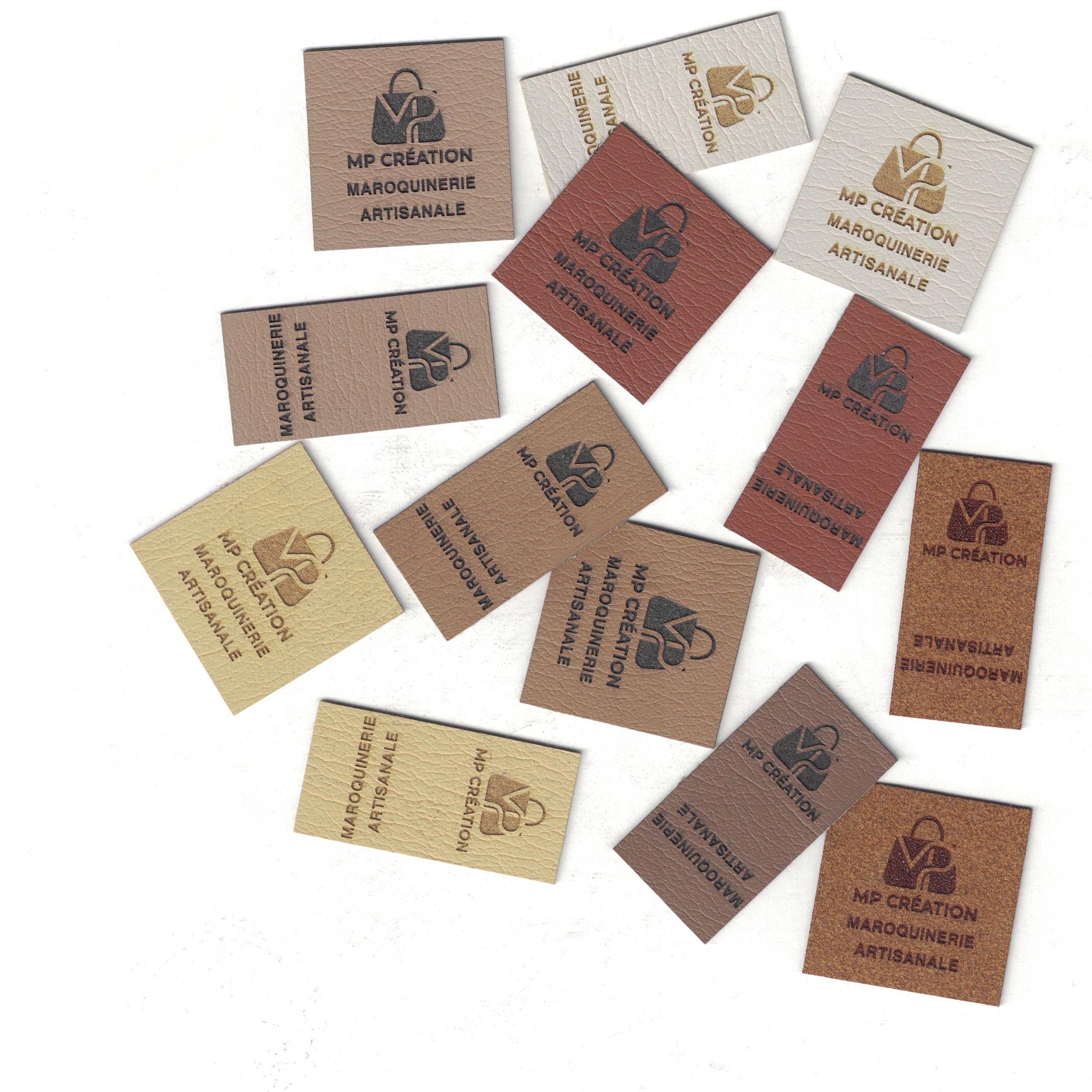 Collection of branded leather labels on a white background